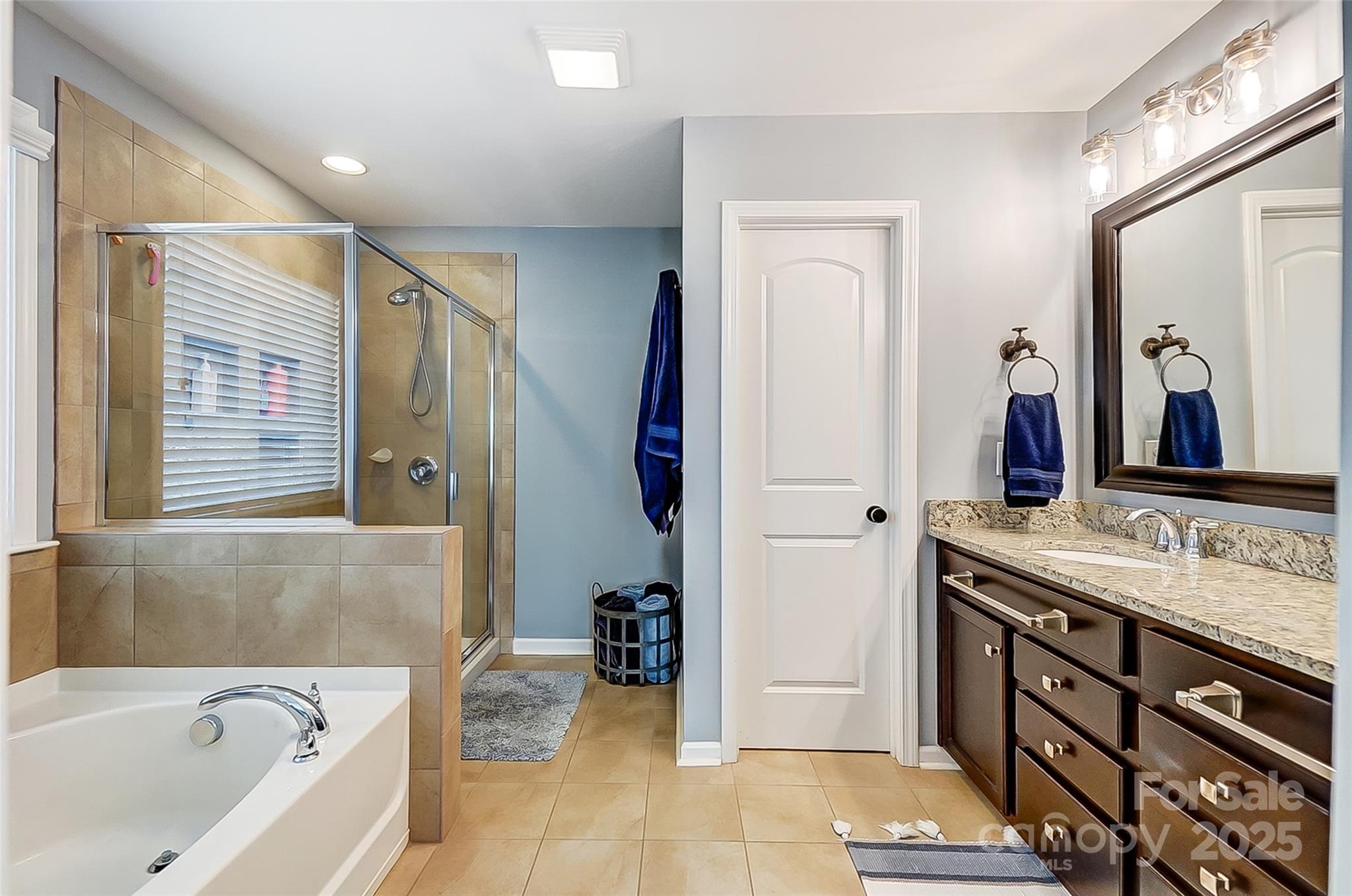 2222 Bluebell Way Fort Mill, SC 29708 - Photo 24 of 41 a bathroom with a tub sink and a mirror