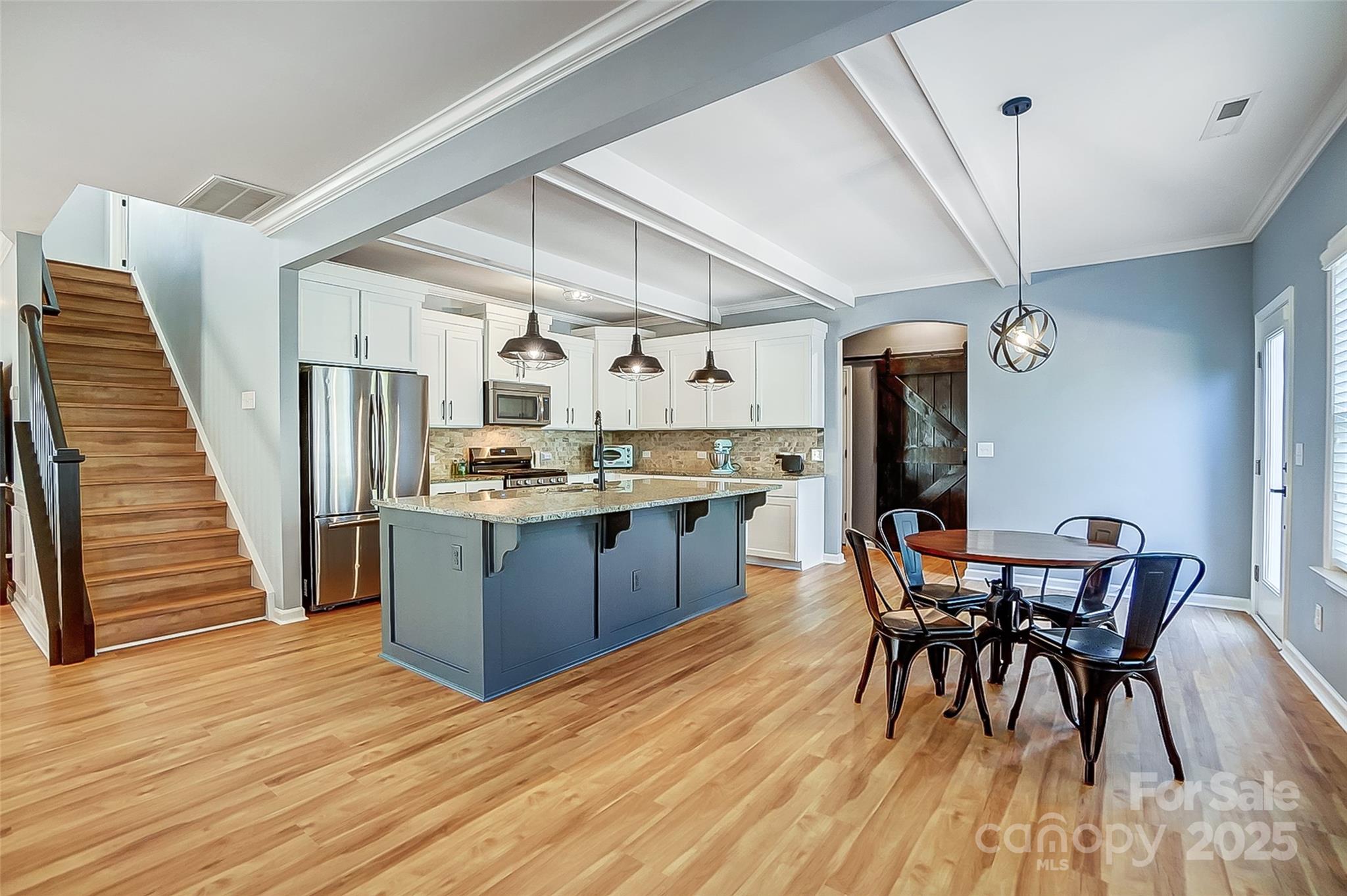 2222 Bluebell Way Fort Mill, SC 29708 - Photo 6 of 41 a kitchen with stainless steel appliances a dining table chairs and wooden floor