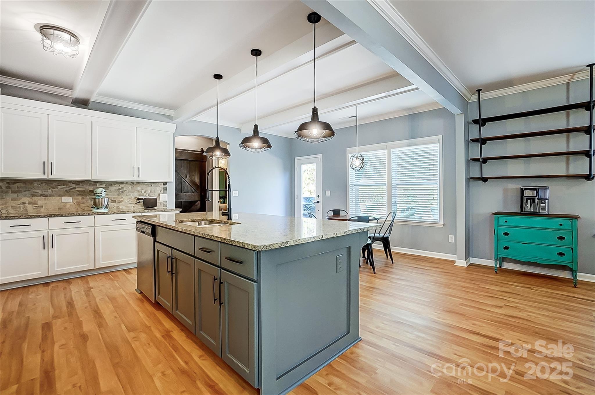 2222 Bluebell Way Fort Mill, SC 29708 - Photo 8 of 41 a kitchen with kitchen island granite countertop a sink cabinets and wooden floor