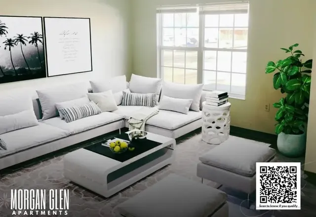 a living room with furniture and a potted plant