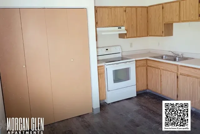 a kitchen with a refrigerator sink and cabinets
