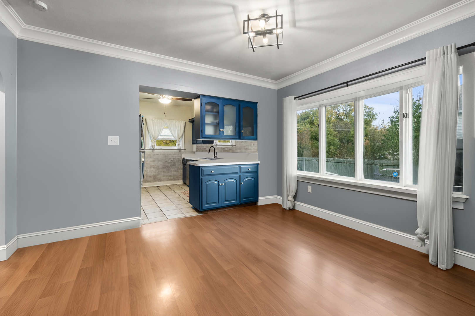 18275 Ada Street Lansing, IL 60438 - Photo 7 of 18 a view of an empty room with a window and wooden floor