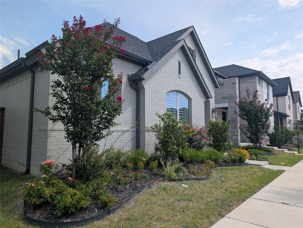 15532 Fringe Tree Road Frisco, TX 75035 - Photo 16 of 31 Modern brick exterior with an arched window and dark trim