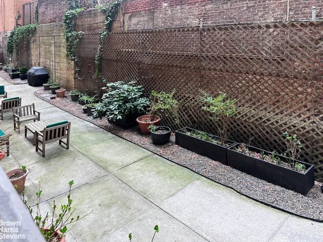 a view of a garden with sitting area