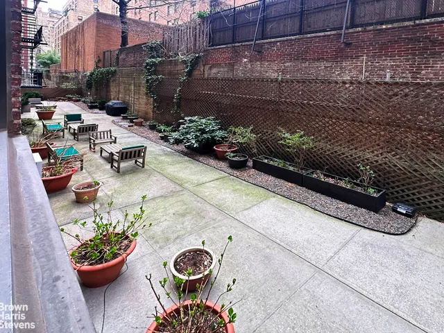 a view of a chairs and tables in a back yard