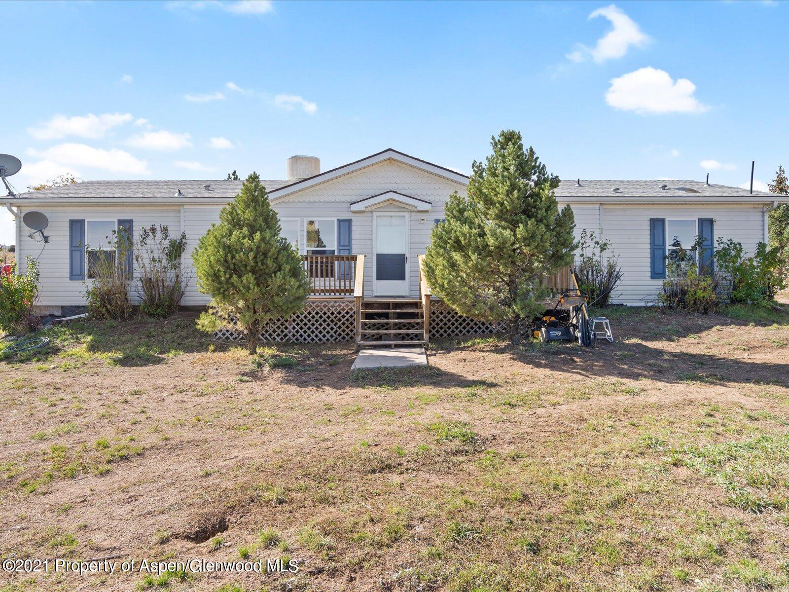 a view of a house with a tree in front of it