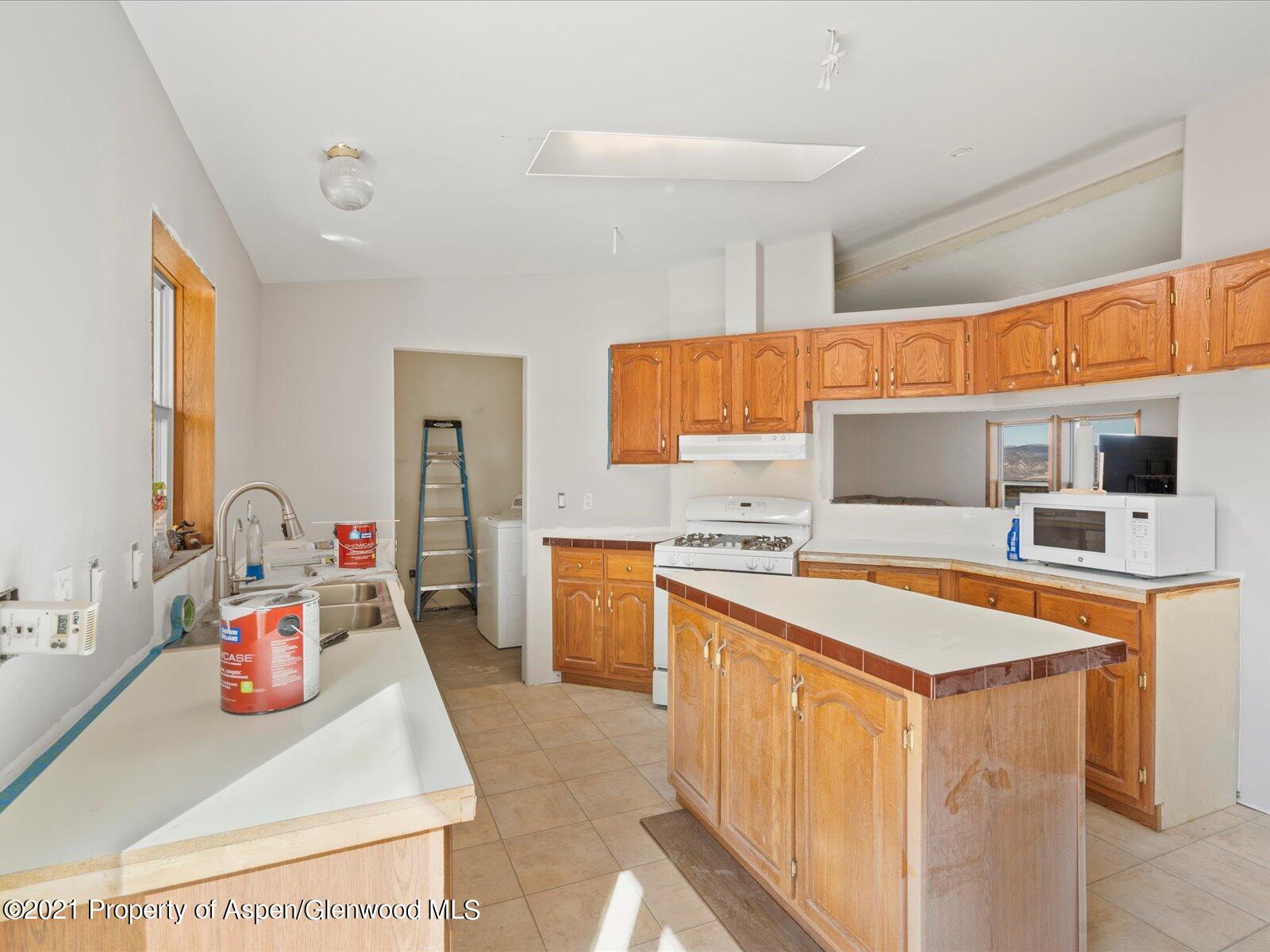 4300 Grass Mesa Road Rifle, CO 81650 - Photo 14 of 45 a kitchen that has a sink and a stove in it