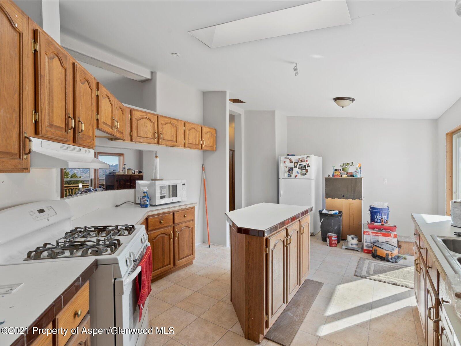 4300 Grass Mesa Road Rifle, CO 81650 - Photo 16 of 45 a kitchen with a sink stove and refrigerator
