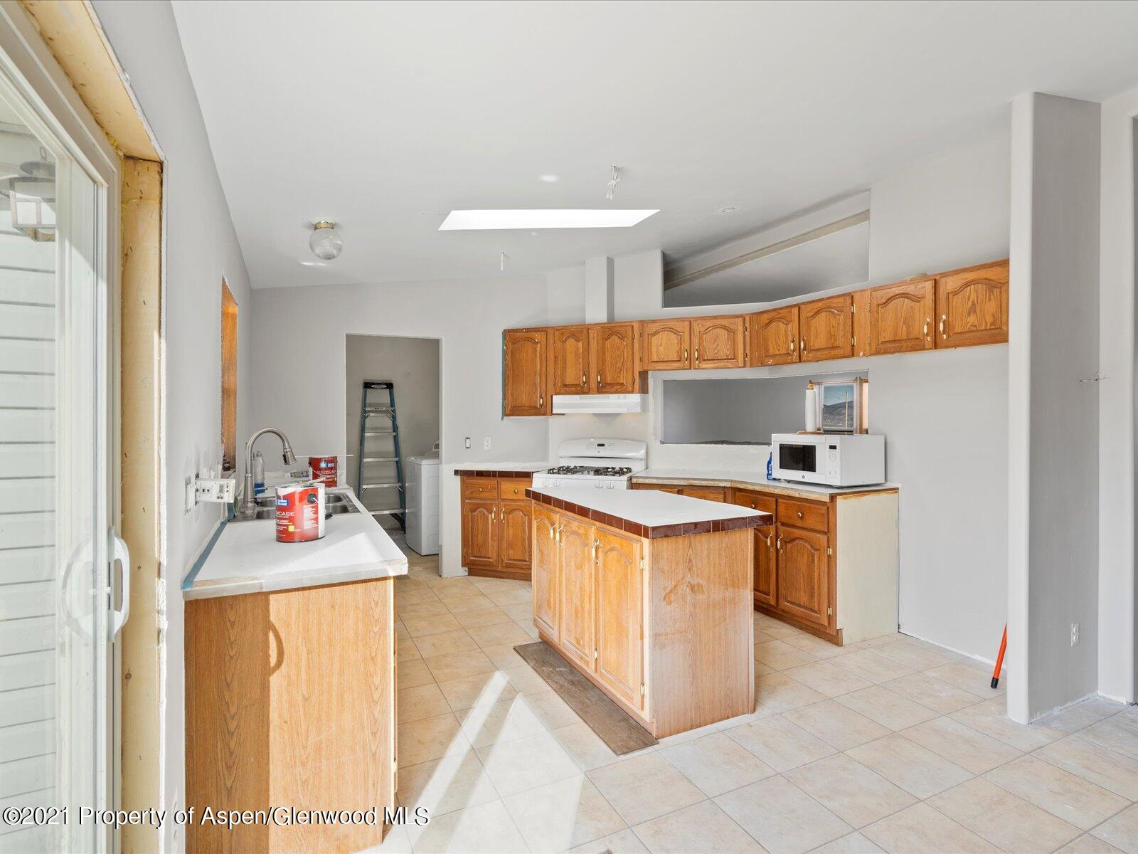 4300 Grass Mesa Road Rifle, CO 81650 - Photo 17 of 45 a kitchen with a sink stove and refrigerator