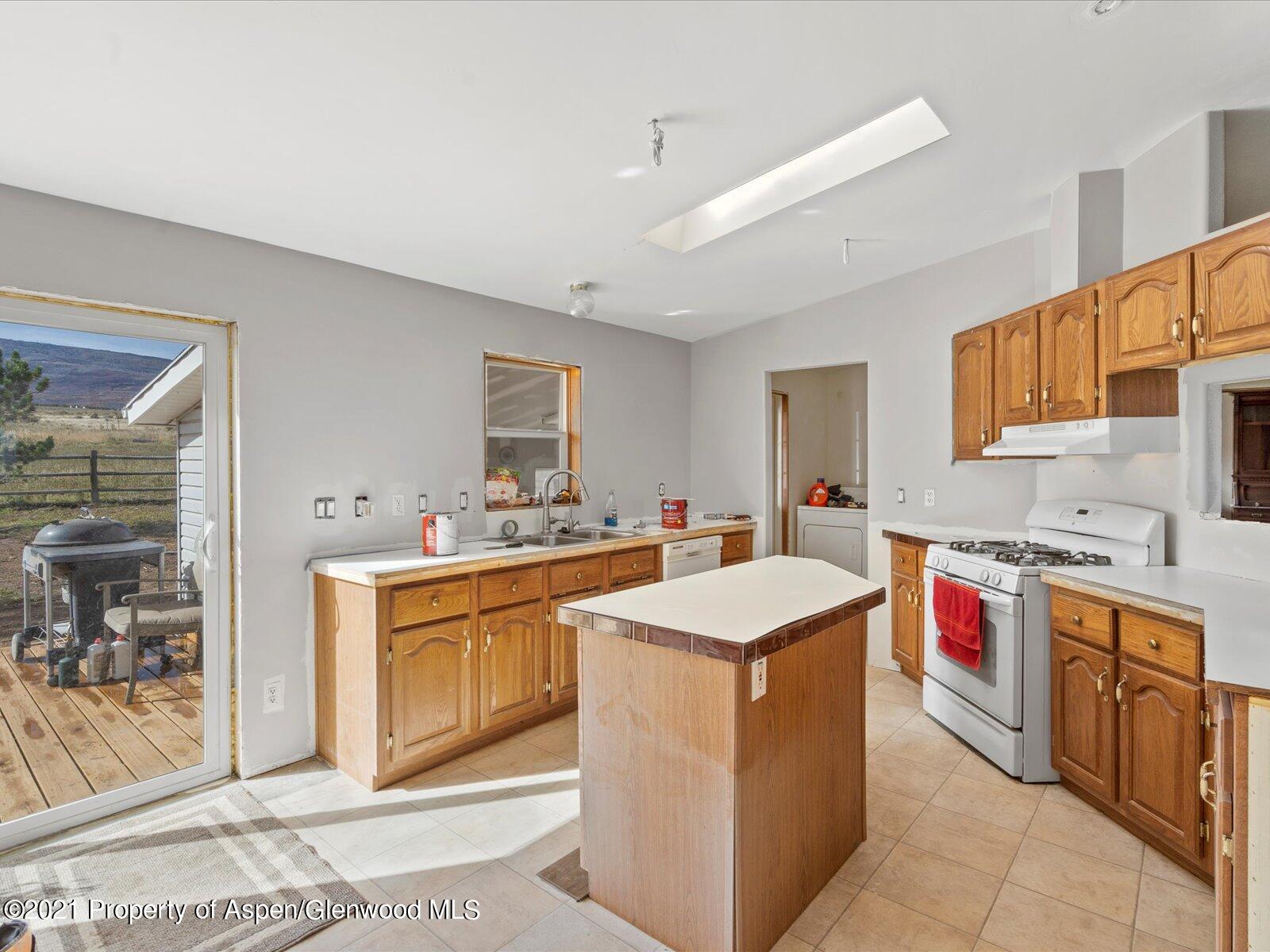4300 Grass Mesa Road Rifle, CO 81650 - Photo 18 of 45 a kitchen with a sink stove and cabinets