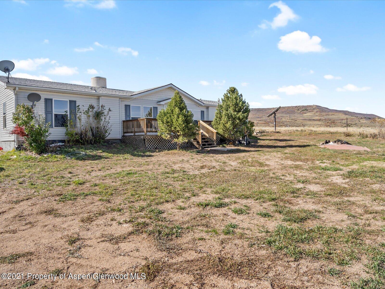 4300 Grass Mesa Road Rifle, CO 81650 - Photo 2 of 45 a view of a house with a yard and potted plants