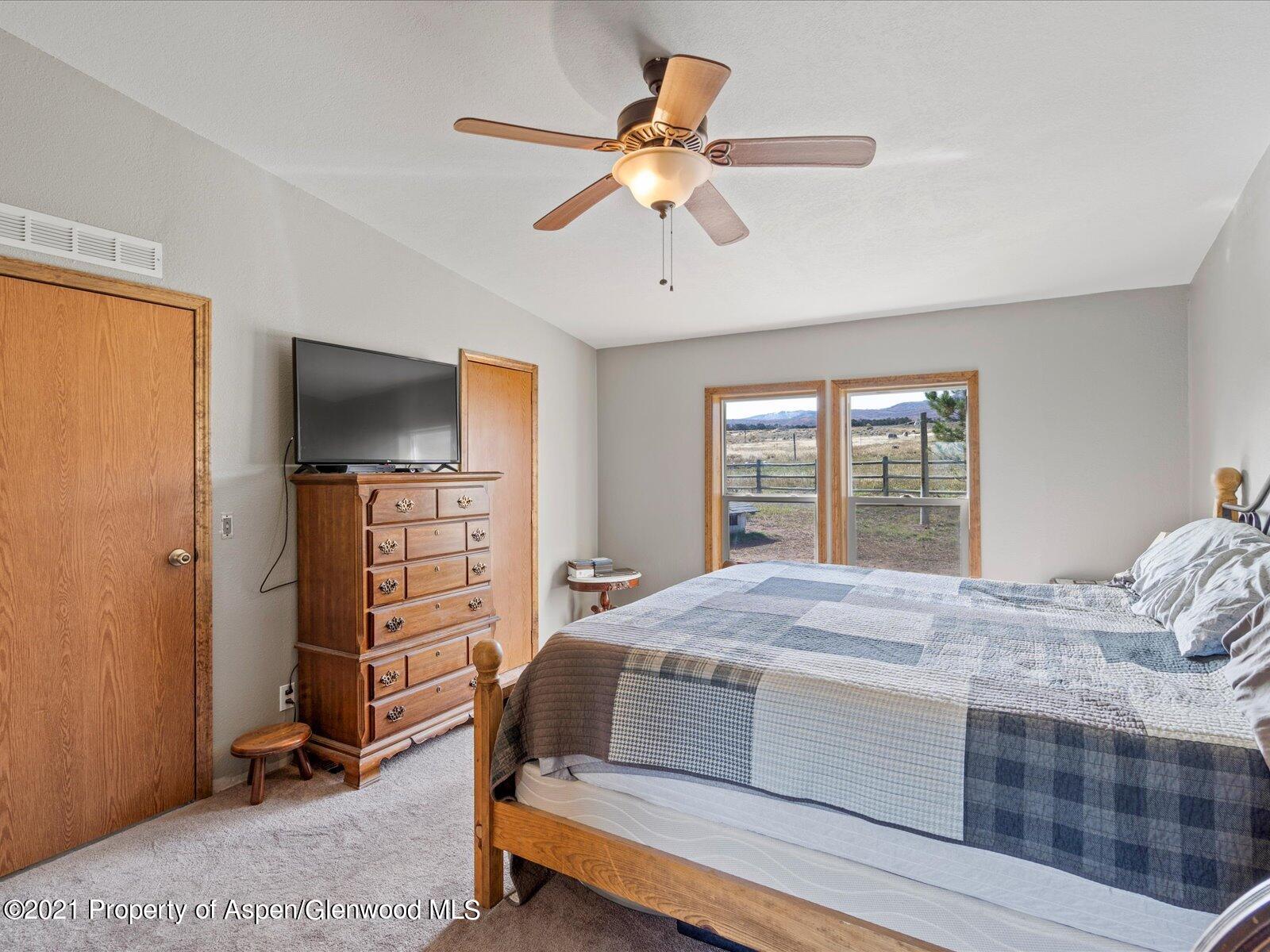 4300 Grass Mesa Road Rifle, CO 81650 - Photo 21 of 45 a bedroom with a bed and a flat screen tv