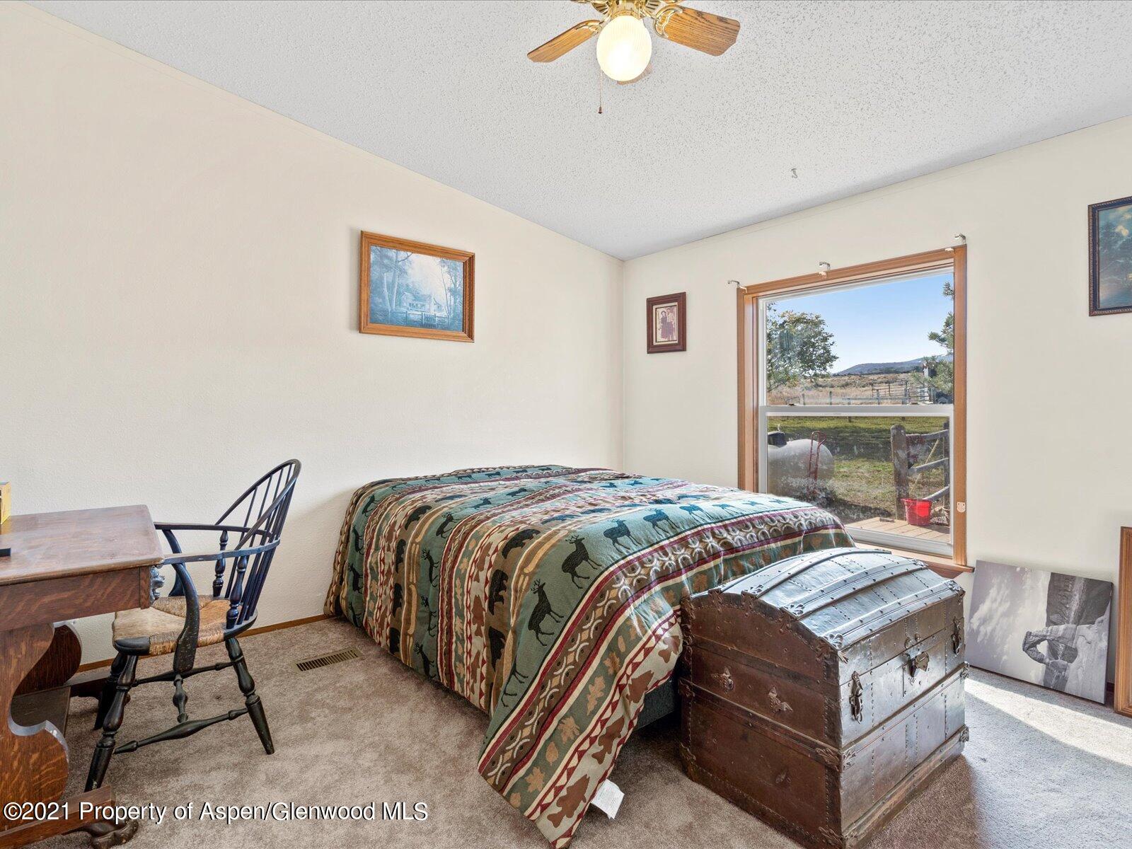 4300 Grass Mesa Road Rifle, CO 81650 - Photo 26 of 45 a bedroom with a bed and chair