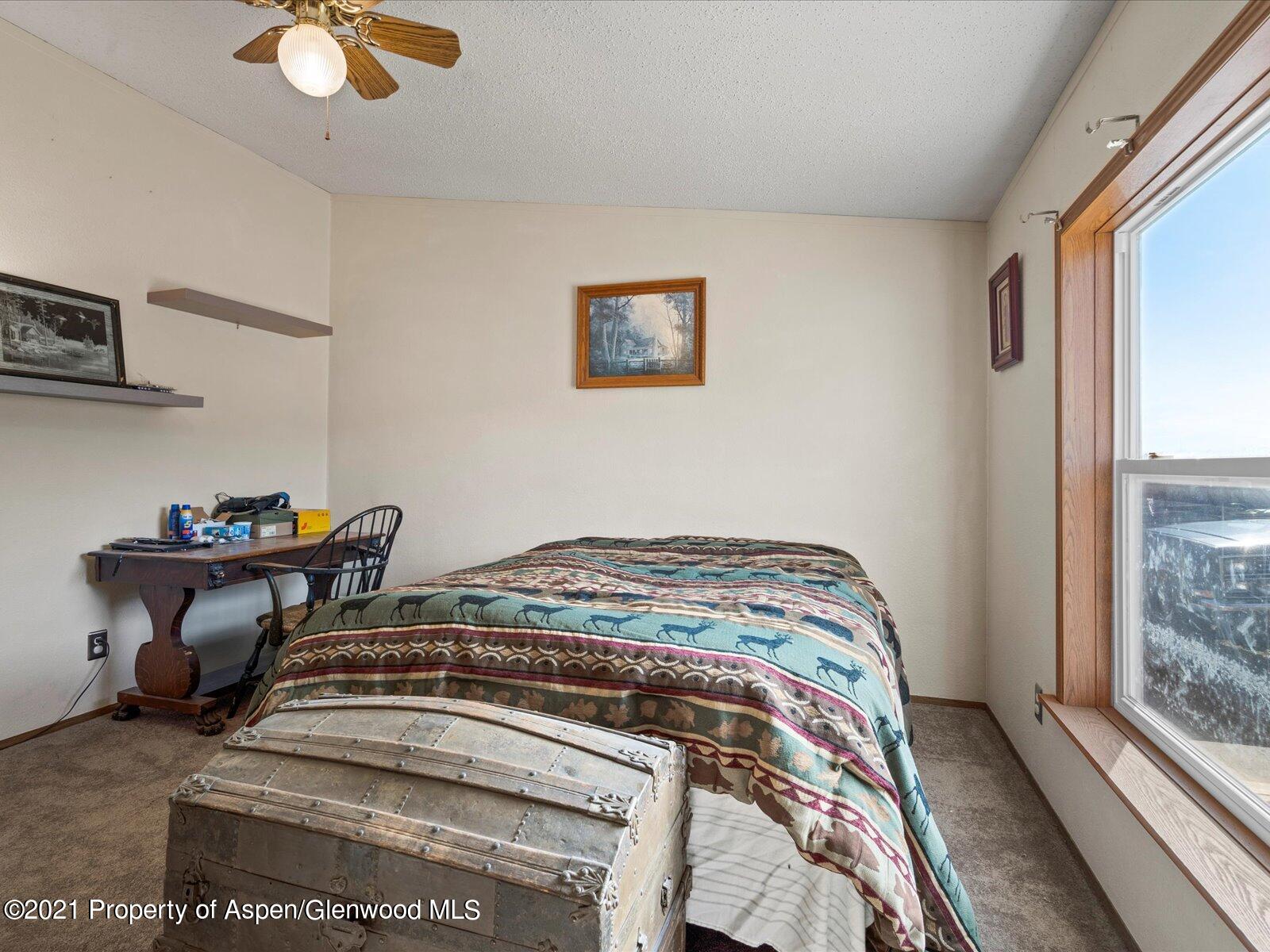 4300 Grass Mesa Road Rifle, CO 81650 - Photo 27 of 45 a bedroom with a bed and a window