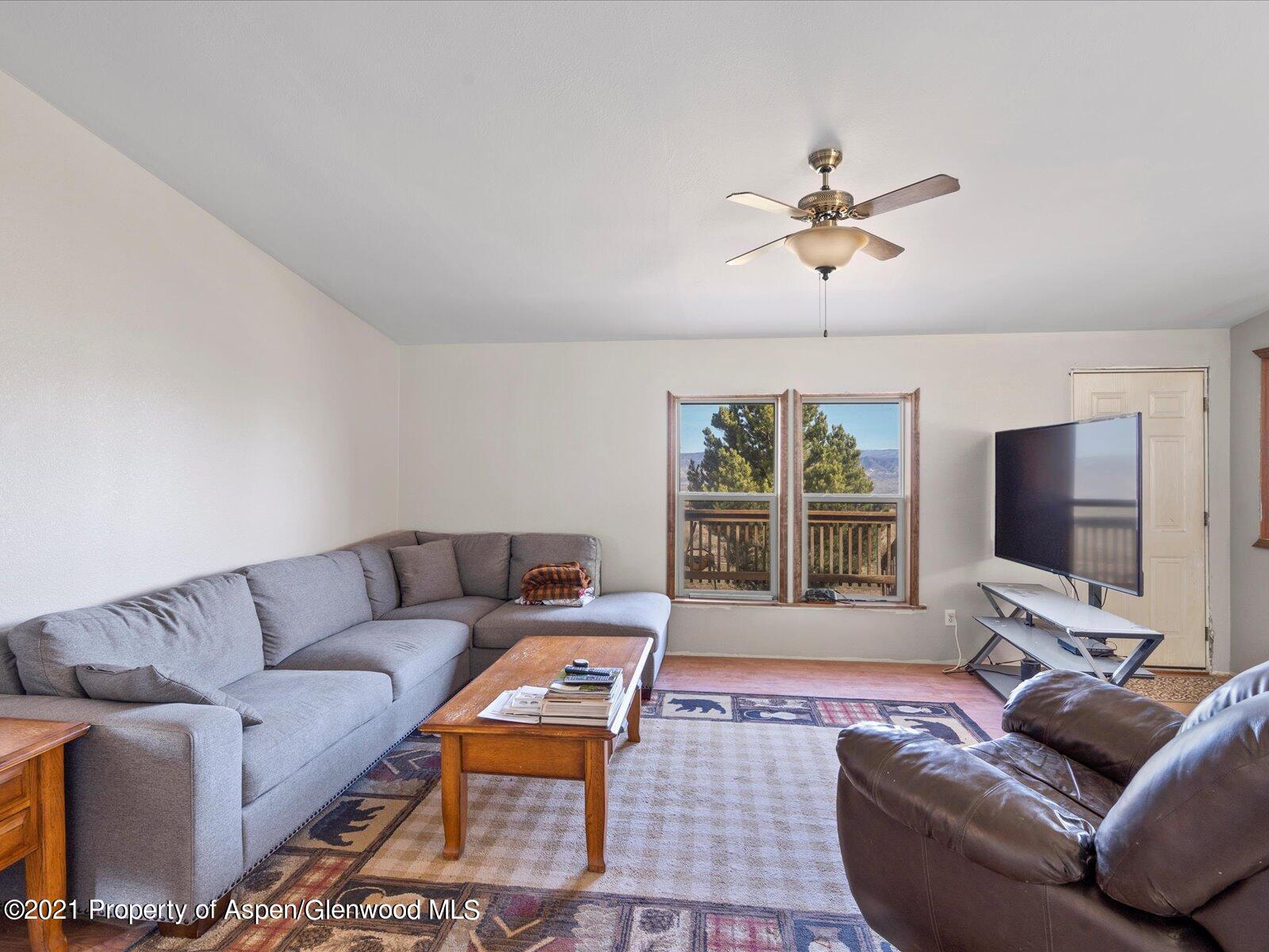4300 Grass Mesa Road Rifle, CO 81650 - Photo 10 of 45 a living room with furniture and a flat screen tv