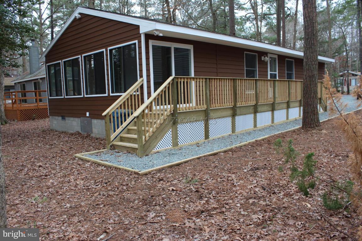 129 Windjammer Road Ocean Pines, MD 21811 - Photo 1 of 36 a view of a house with a deck and a yard