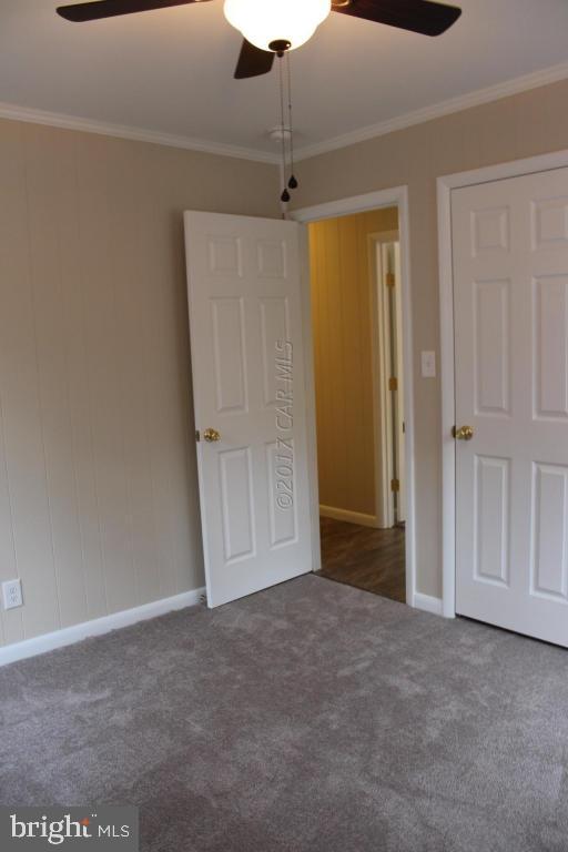 129 Windjammer Road Ocean Pines, MD 21811 - Photo 18 of 36 an empty room with closet and a chandelier fan