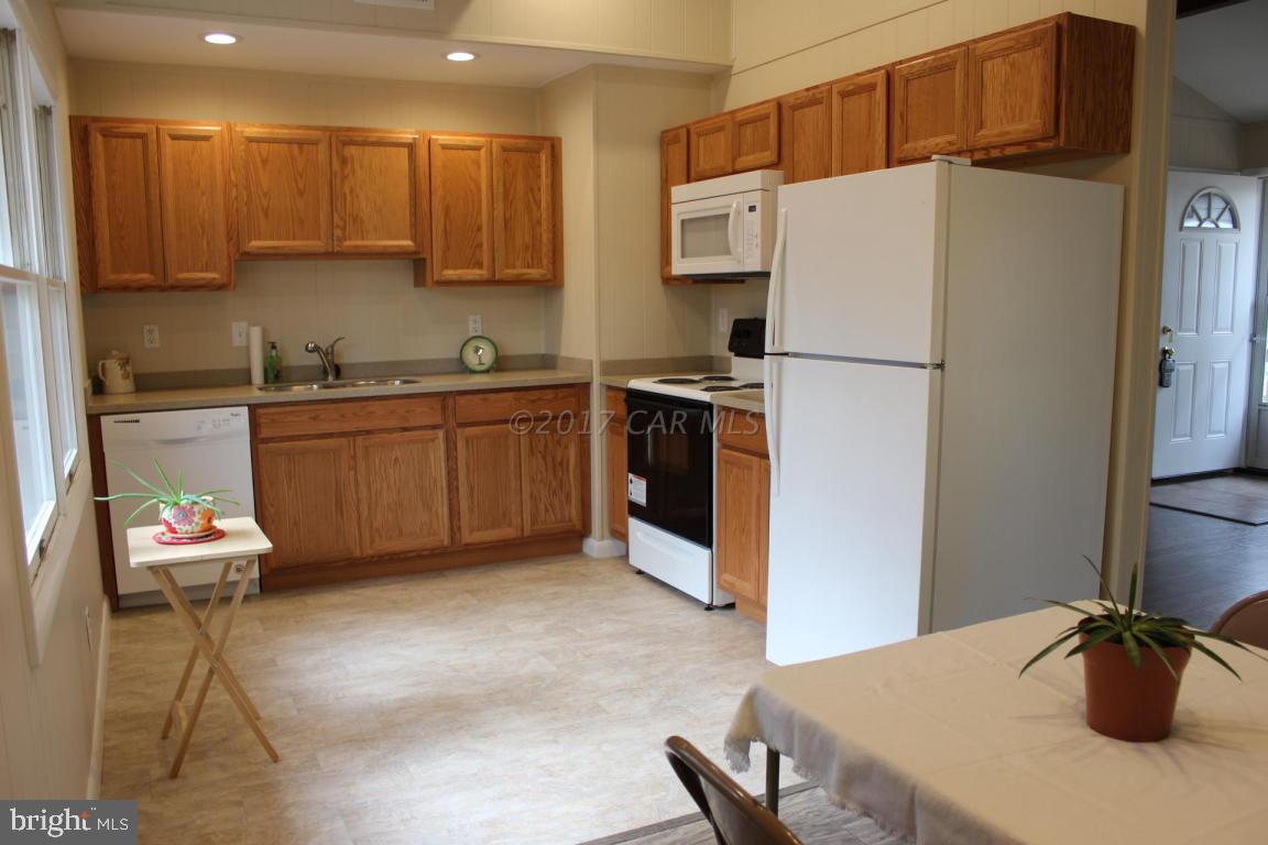 129 Windjammer Road Ocean Pines, MD 21811 - Photo 19 of 36 a kitchen with stainless steel appliances a stove refrigerator sink and a microwave