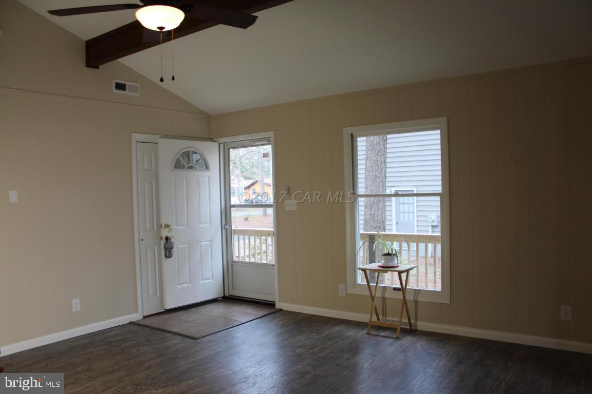 129 Windjammer Road Ocean Pines, MD 21811 - Photo 3 of 36 an empty room with wooden floor and windows