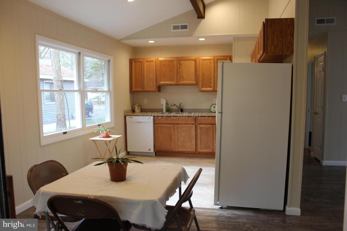 129 Windjammer Road Ocean Pines, MD 21811 - Photo 21 of 36 a kitchen with a table chairs and refrigerator