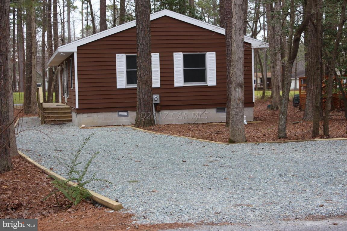 129 Windjammer Road Ocean Pines, MD 21811 - Photo 36 of 36 a front view of a house with a yard and garage