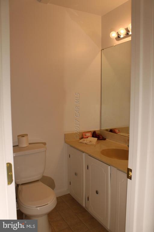 129 Windjammer Road Ocean Pines, MD 21811 - Photo 8 of 36 a bathroom with a granite countertop toilet and a sink