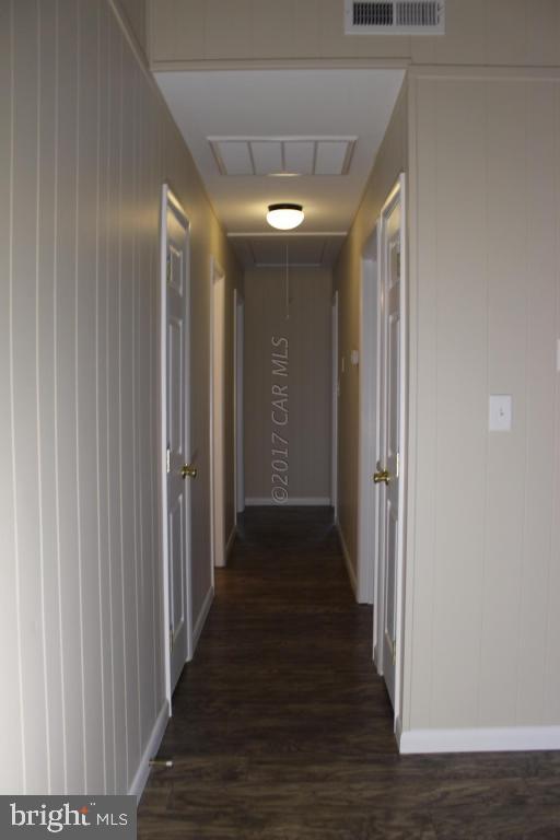 129 Windjammer Road Ocean Pines, MD 21811 - Photo 9 of 36 a view of a hallway with wooden floor