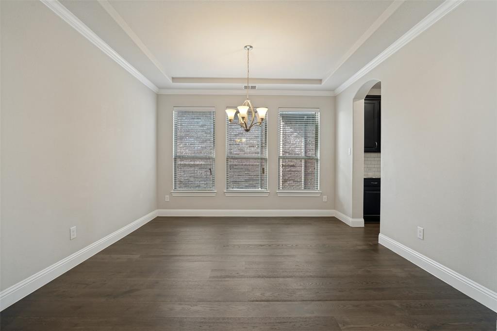 2802 Merlot Circle Rowlett, TX 75088 - Photo 17 of 40 an empty room with chandelier fan and windows