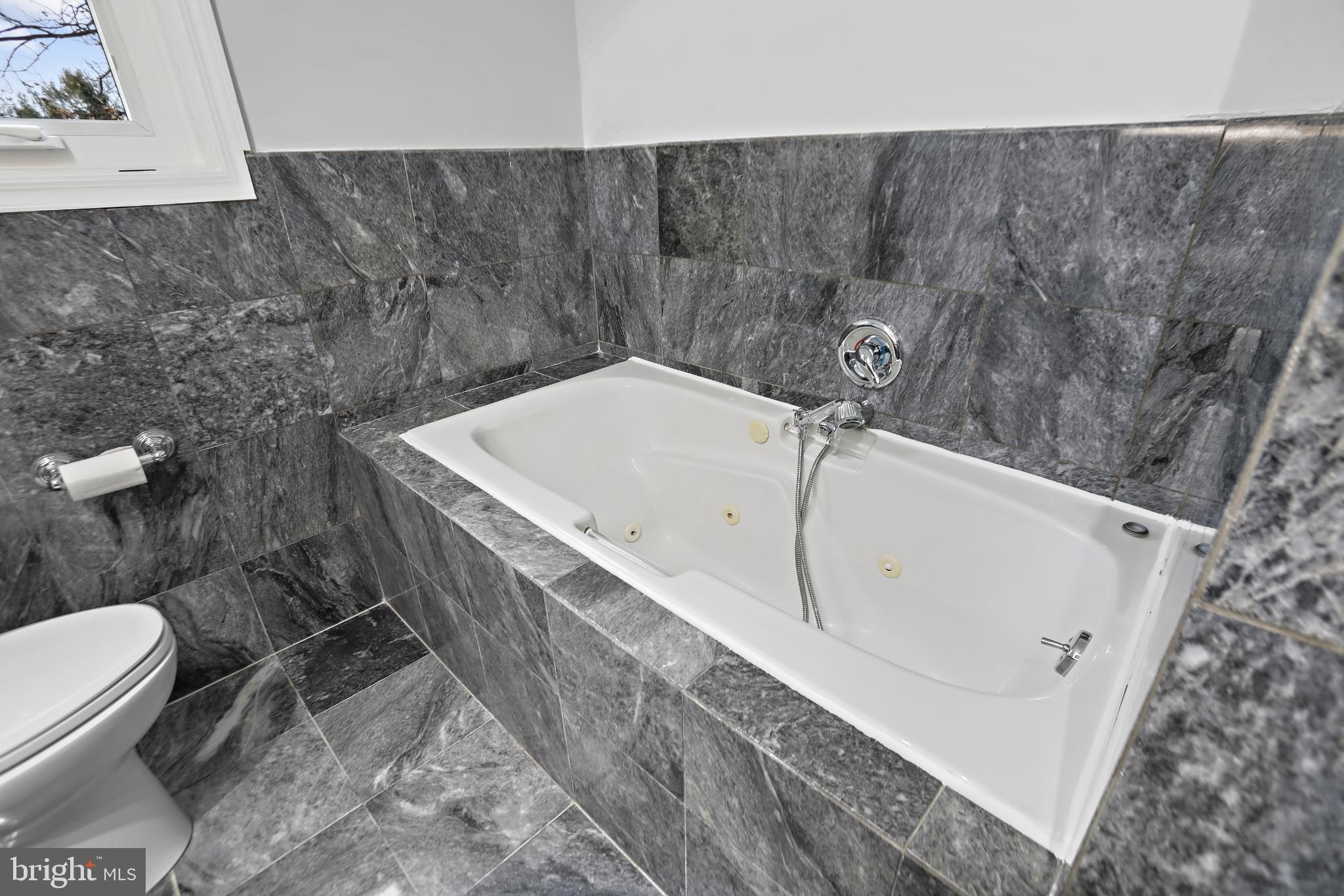 3906 Ridge Road Annandale, VA 22003 - Photo 14 of 34 Sleek marble bath retreat for relaxation.
