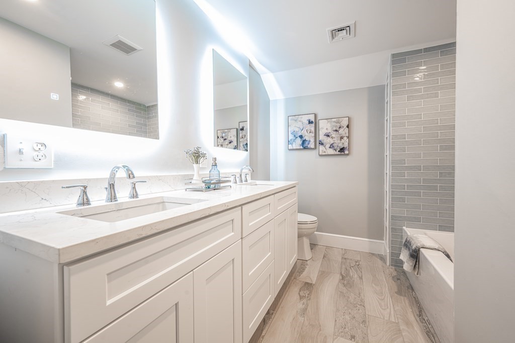 61 Sheffield Road Melrose, MA 02176 - Photo 13 of 21 a spacious bathroom with a sink a toilet a shower and a mirror