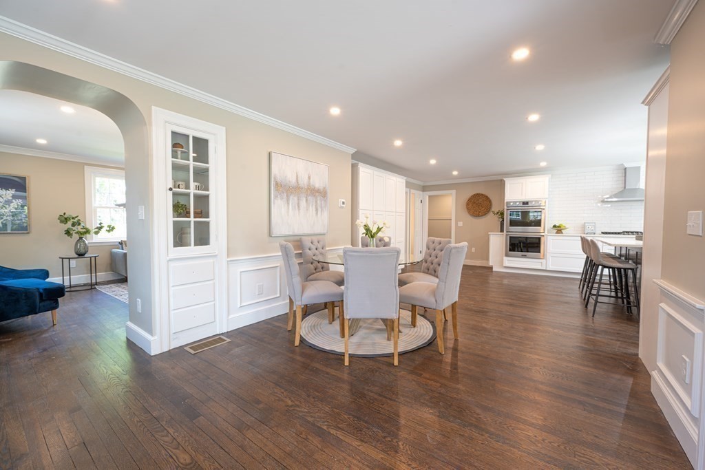 61 Sheffield Road Melrose, MA 02176 - Photo 8 of 21 a dining room with furniture wooden floor and a kitchen