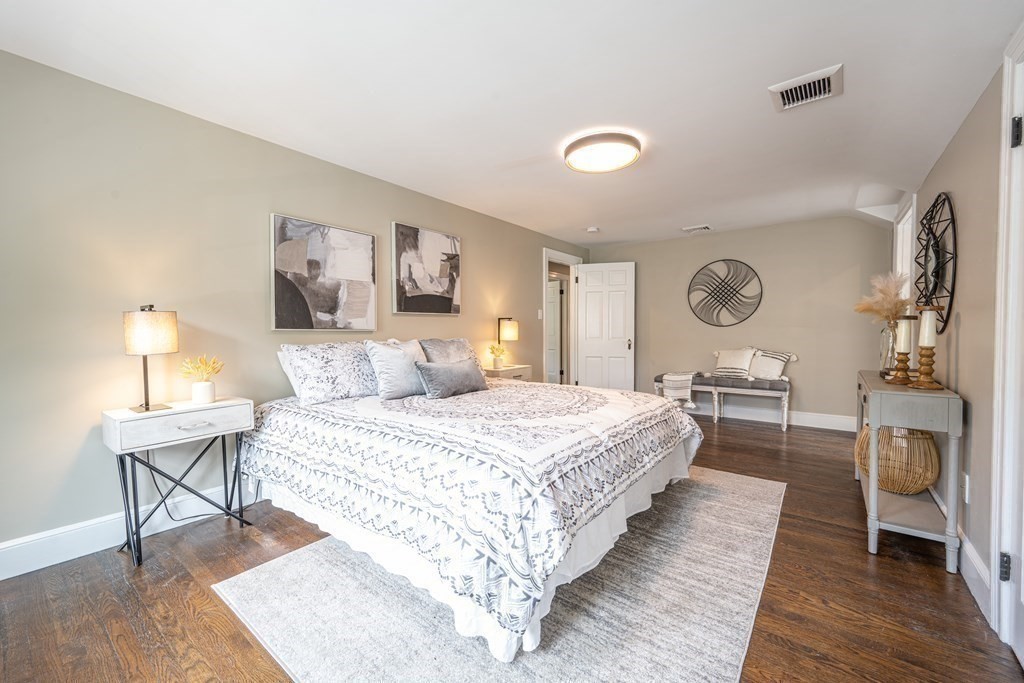61 Sheffield Road Melrose, MA 02176 - Photo 10 of 21 a spacious bedroom with a bed and a lamp on table