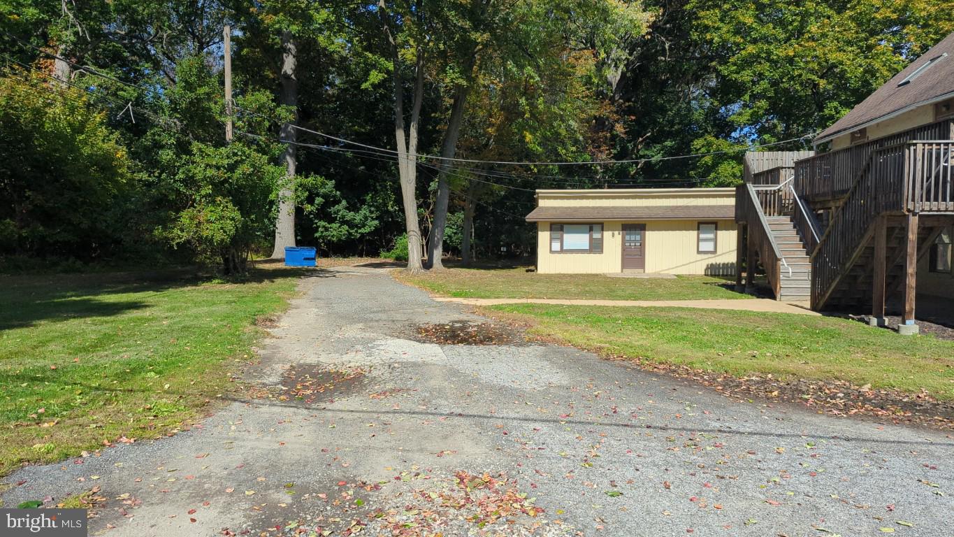 900 Main Street Brookhaven, PA 19015 - Photo 16 of 42 a front view of a house with a big yard and palm trees