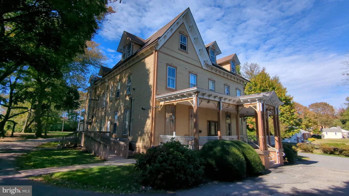 900 Main Street Brookhaven, PA 19015 - Photo 2 of 42 a front view of a house with a garden