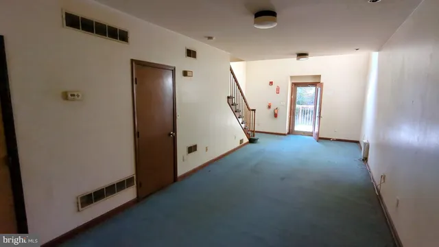 a view of a livingroom with stairs