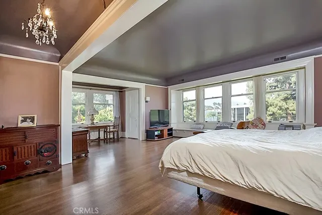 a spacious bedroom with a large bed and large windows