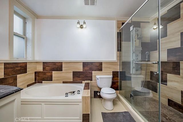 a bathroom with a toilet a sink and a shower