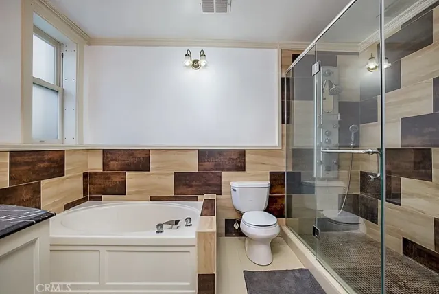 a bathroom with a toilet a sink and a shower