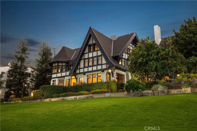 a front view of a house with a garden