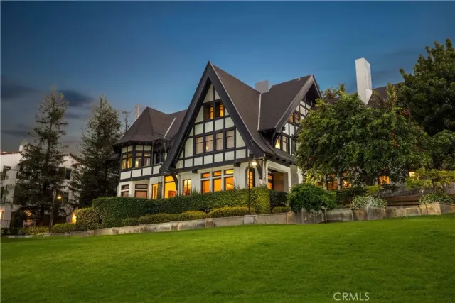 a front view of a house with a garden