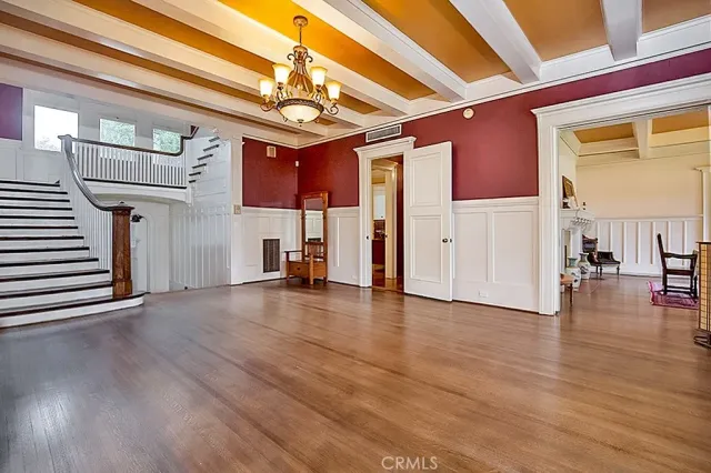 a view of a livingroom with wooden floor and a ceiling fan