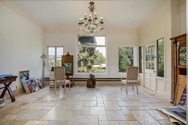 a living room with furniture a fireplace and large windows