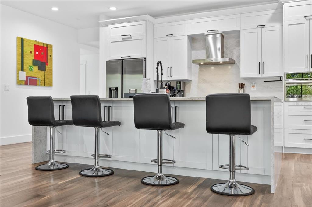7301 South Elliott Street Tampa, FL 33616 - Photo 13 of 54 a kitchen with stainless steel appliances granite countertop a table chair and granite counter tops
