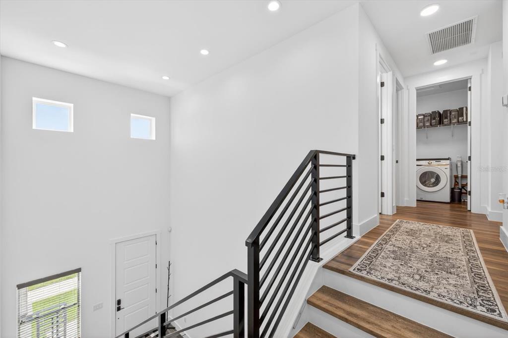 7301 South Elliott Street Tampa, FL 33616 - Photo 21 of 54 a view of a hallway to a livingroom with wooden floor and windows