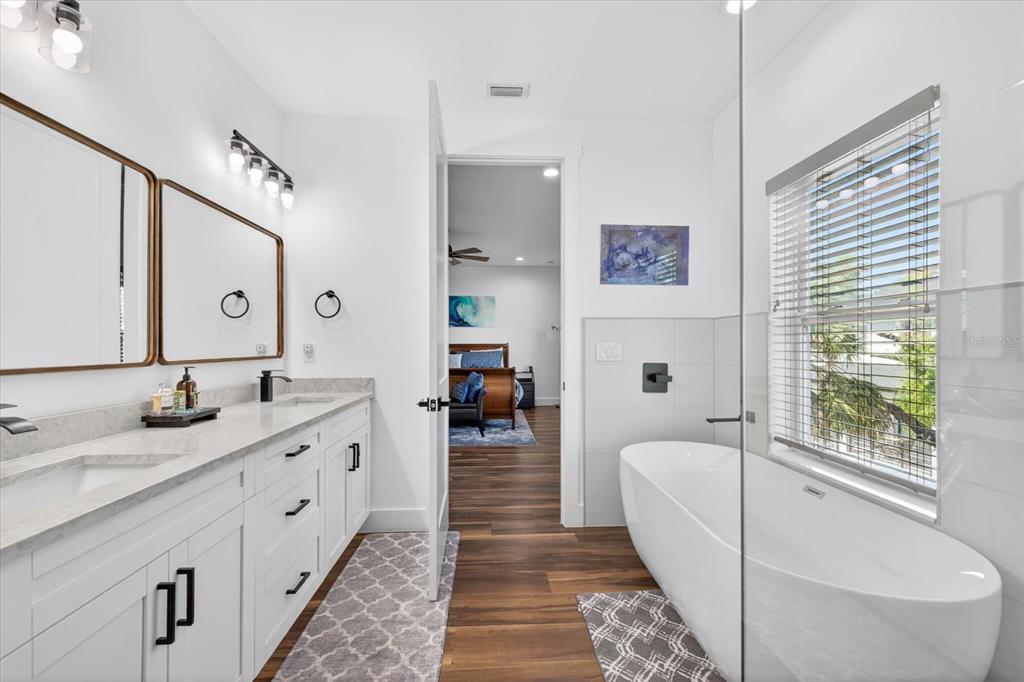 7301 South Elliott Street Tampa, FL 33616 - Photo 38 of 54 a bathroom with a granite countertop sink and a mirror