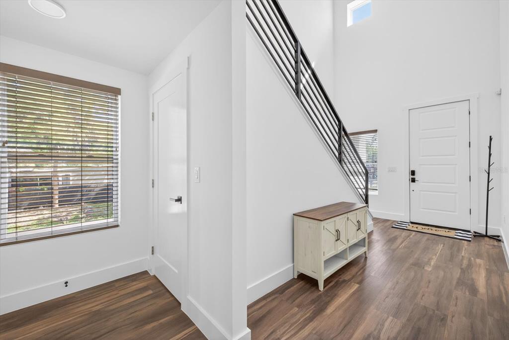 7301 South Elliott Street Tampa, FL 33616 - Photo 5 of 54 a view of an entryway with wooden floor and stairs