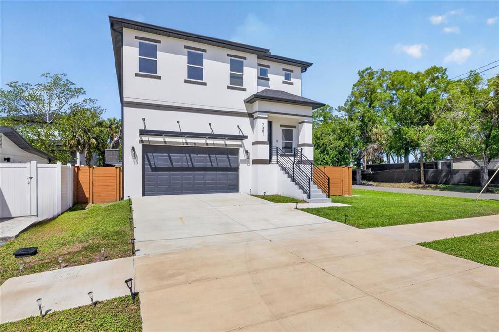 7301 South Elliott Street Tampa, FL 33616 - Photo 54 of 54 a front view of a house with a yard and garage