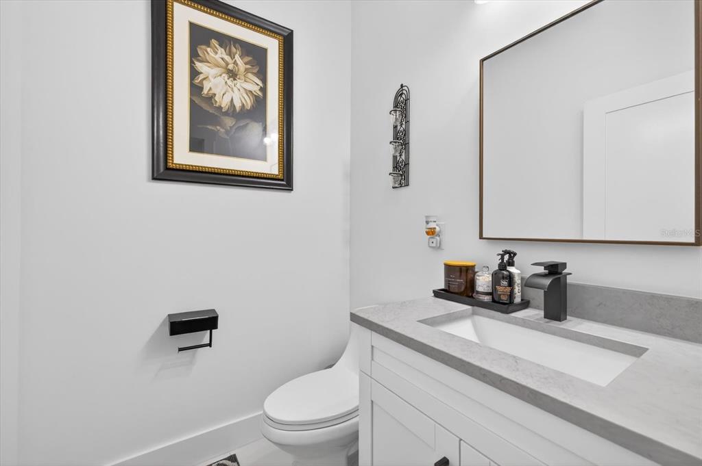 7301 South Elliott Street Tampa, FL 33616 - Photo 6 of 54 a bathroom with a toilet a sink and mirror