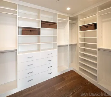 a view of walk in closet with empty racks
