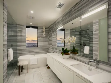 a bathroom with a double vanity sink and a bathtub